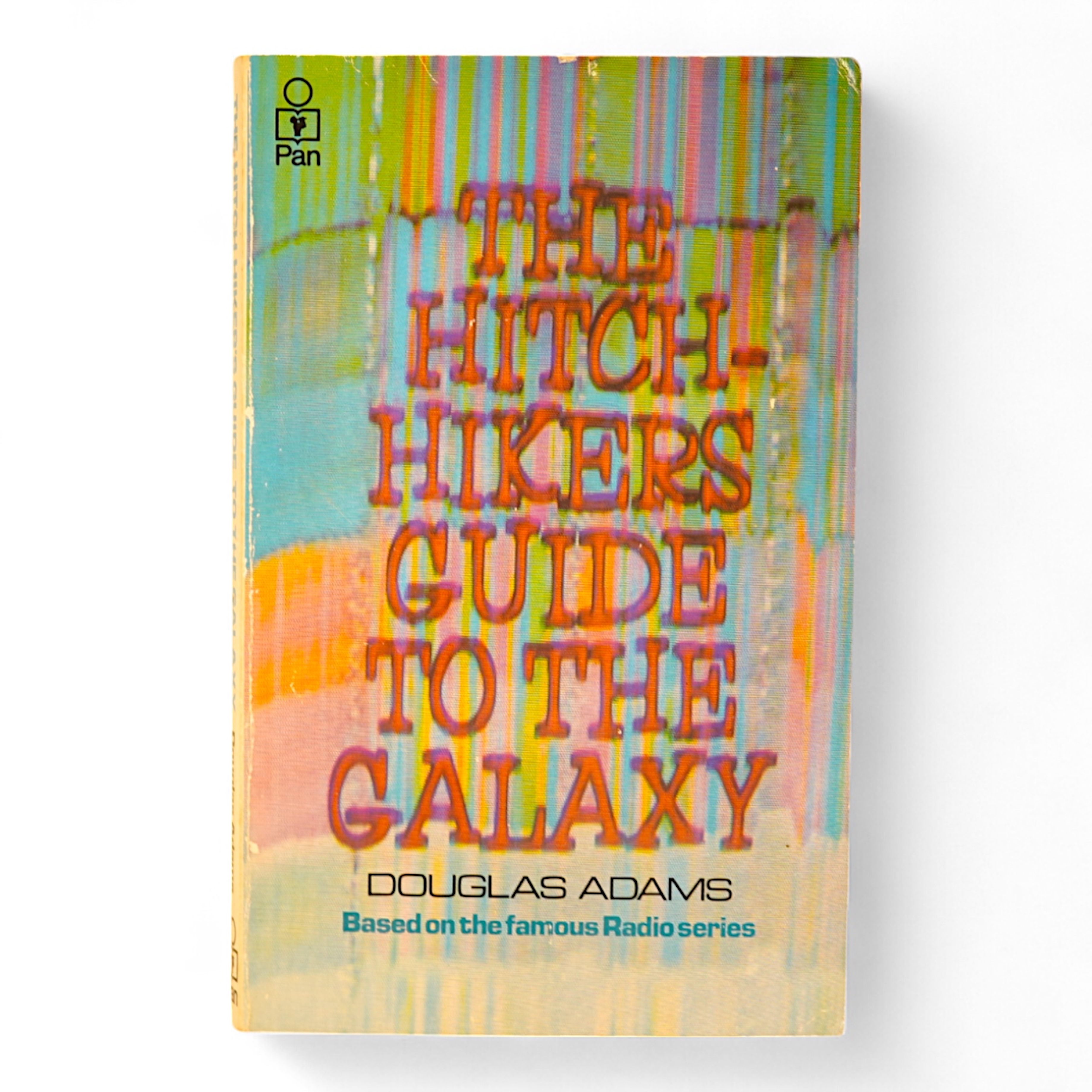 Adams, Douglas - The Hitch Hiker's Guide to the Galaxy. first edition, 2nd printing. half title/radio series leaf; paperback, sm. 8vo. Pan Books, 1979. *published same year as first and with a differently designed cover;